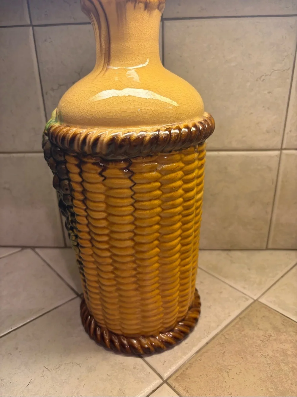 Majolica style ceramic vase featuring an embossed grape and basket weave motif.